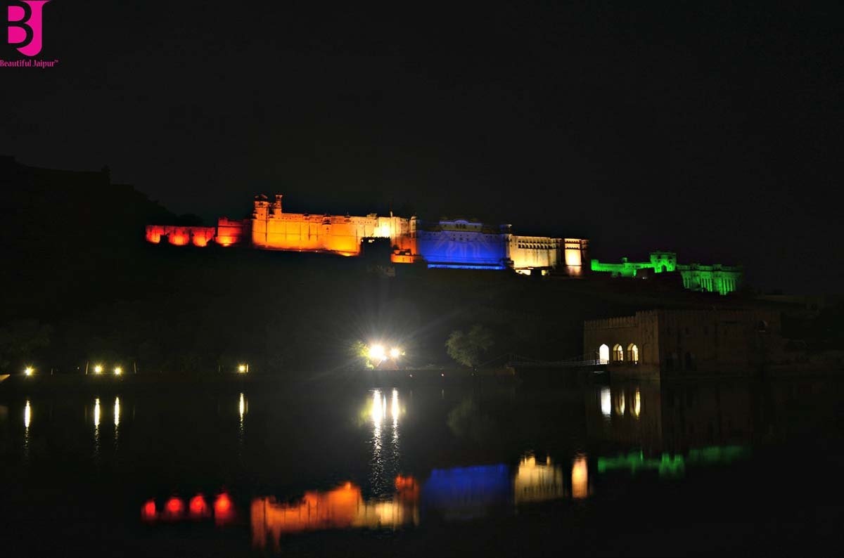 Amer Fort illuminated at night and reflected in Maota Lake Jaipur