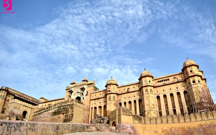 Wide exterior view of Amer Fort Jaipur under a blue sky