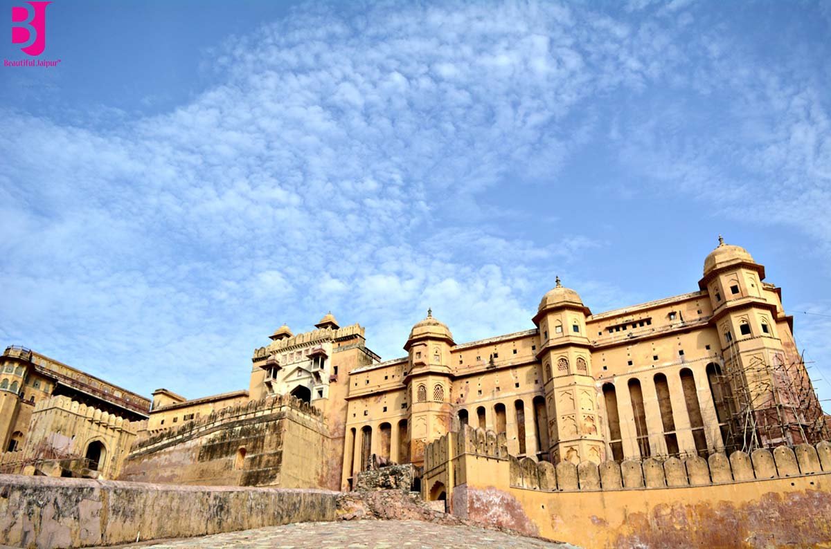 Wide exterior view of Amer Fort Jaipur under a blue sky