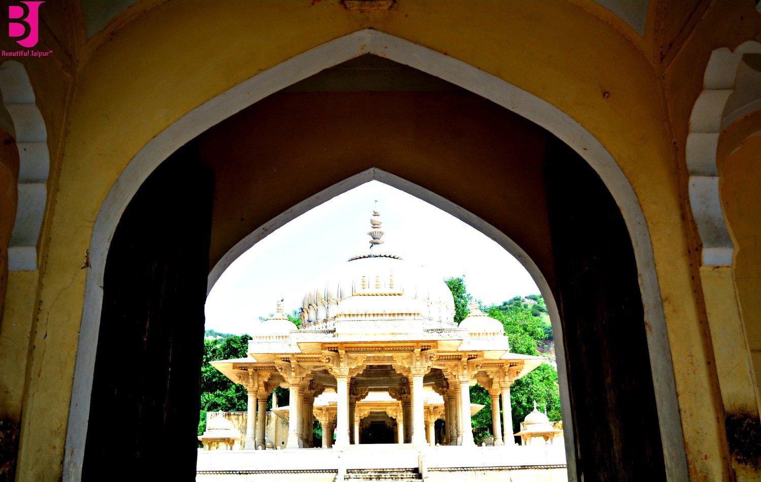 Royal cenotaph framed through the entrance arch at Gaitore Ki Chhatriyan Jaipur