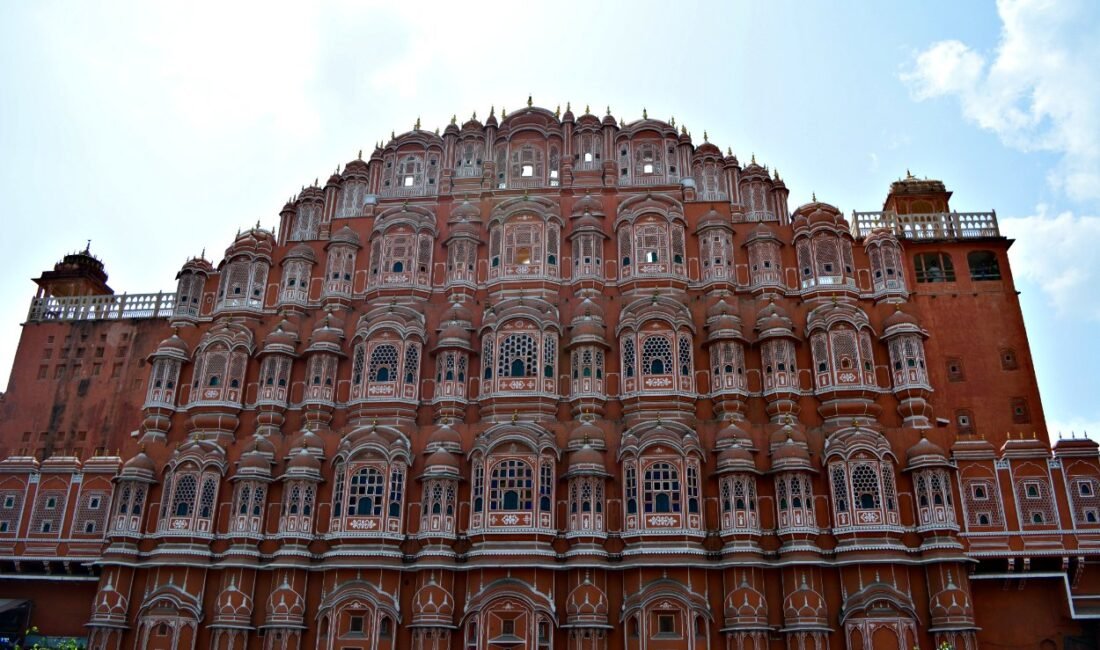 Iconic front facade of Hawa Mahal Jaipur with its pink jharokhas