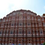 Iconic front facade of Hawa Mahal Jaipur with its pink jharokhas