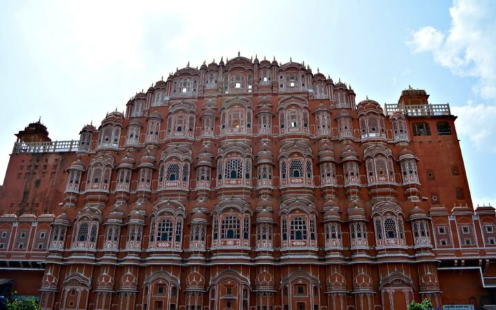Iconic front facade of Hawa Mahal Jaipur with its pink jharokhas