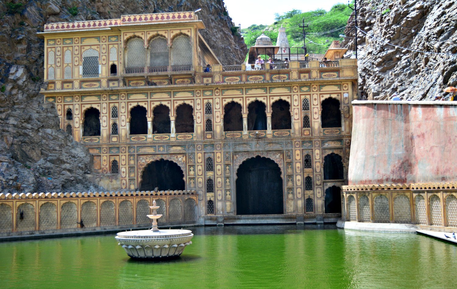 Sacred kund and painted facade inside Galtaji Temple Jaipur
