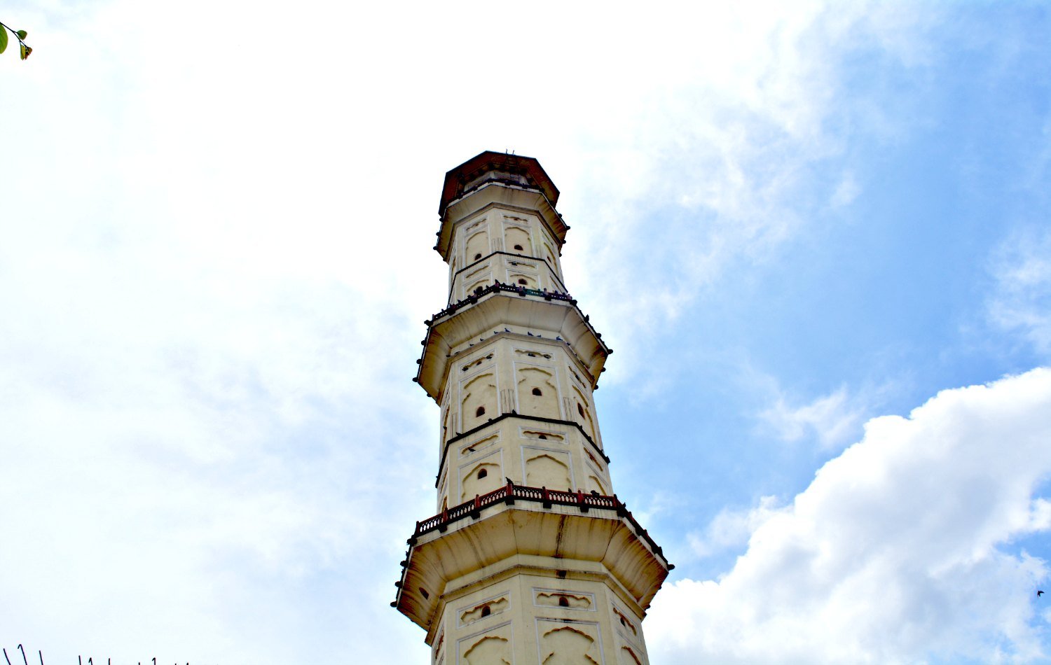 Low-angle view of the upper levels of Sargasuli Tower in Jaipur