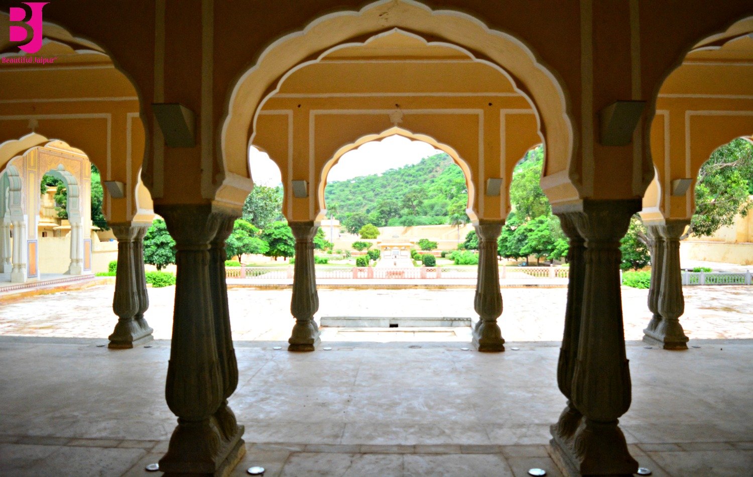 Garden view framed by traditional arches at Vidyadhar Garden Jaipur