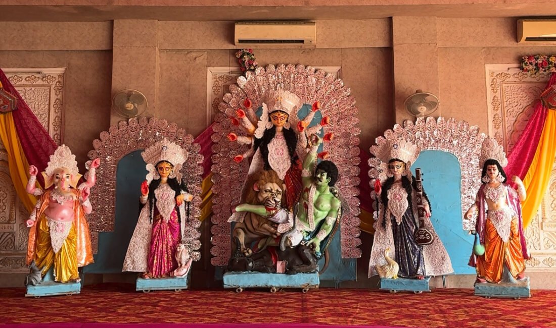 Durga idol with an ornate white backdrop and accompanying deities in Jaipur