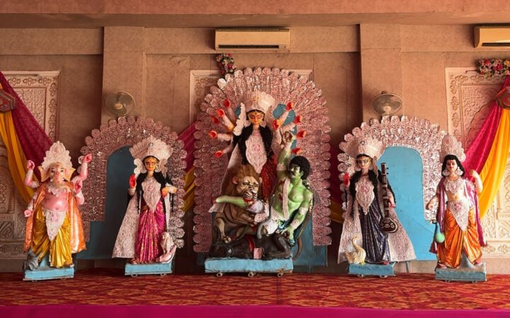 Durga idol with an ornate white backdrop and accompanying deities in Jaipur