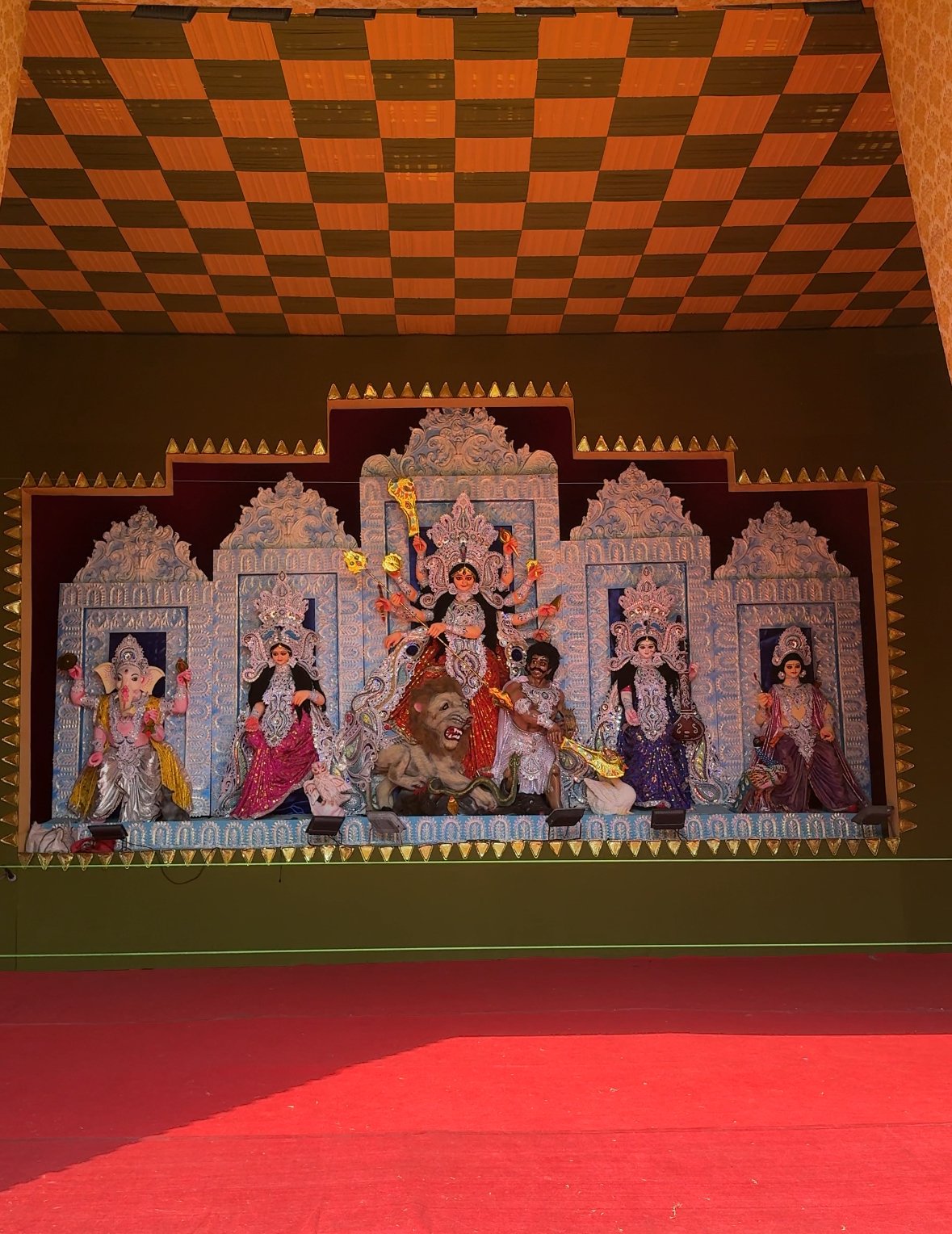 Durga Puja idol arrangement with ornate pale blue panels in Jaipur