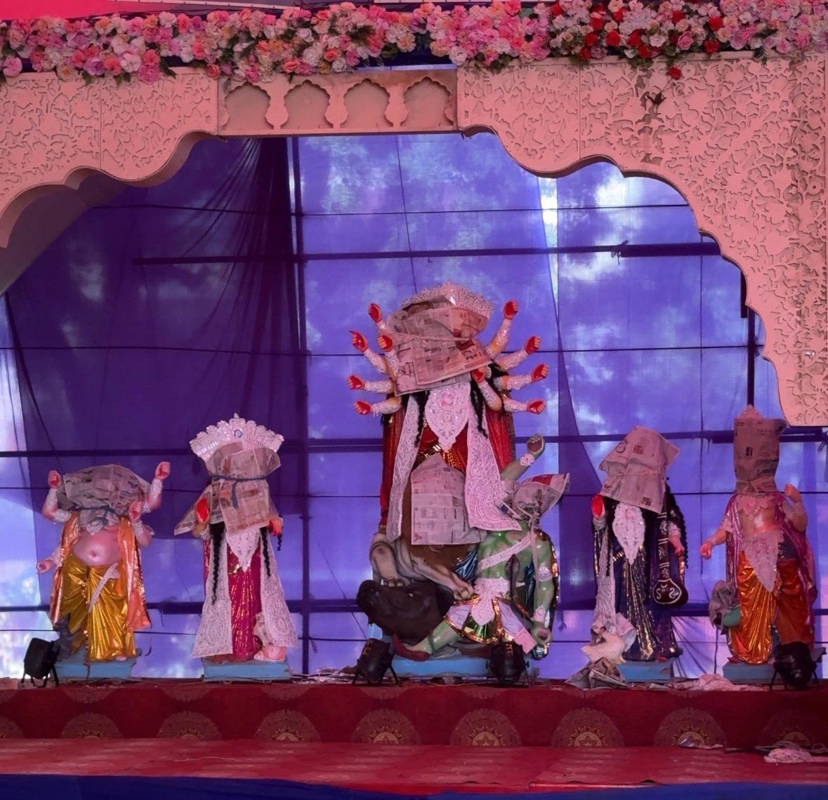 Durga Puja idols with faces covered during preparations in Jaipur