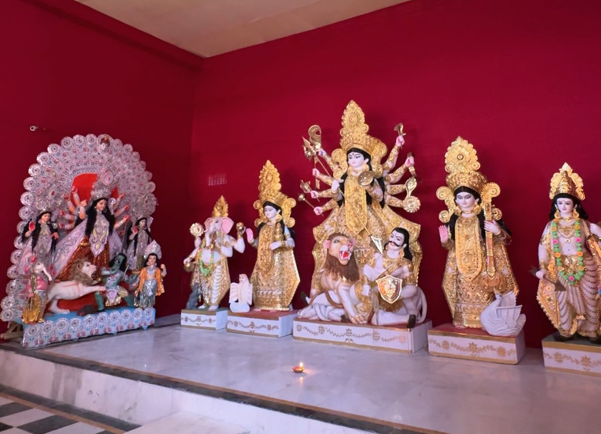 Gold-coloured Durga idols displayed against a red backdrop in Jaipur